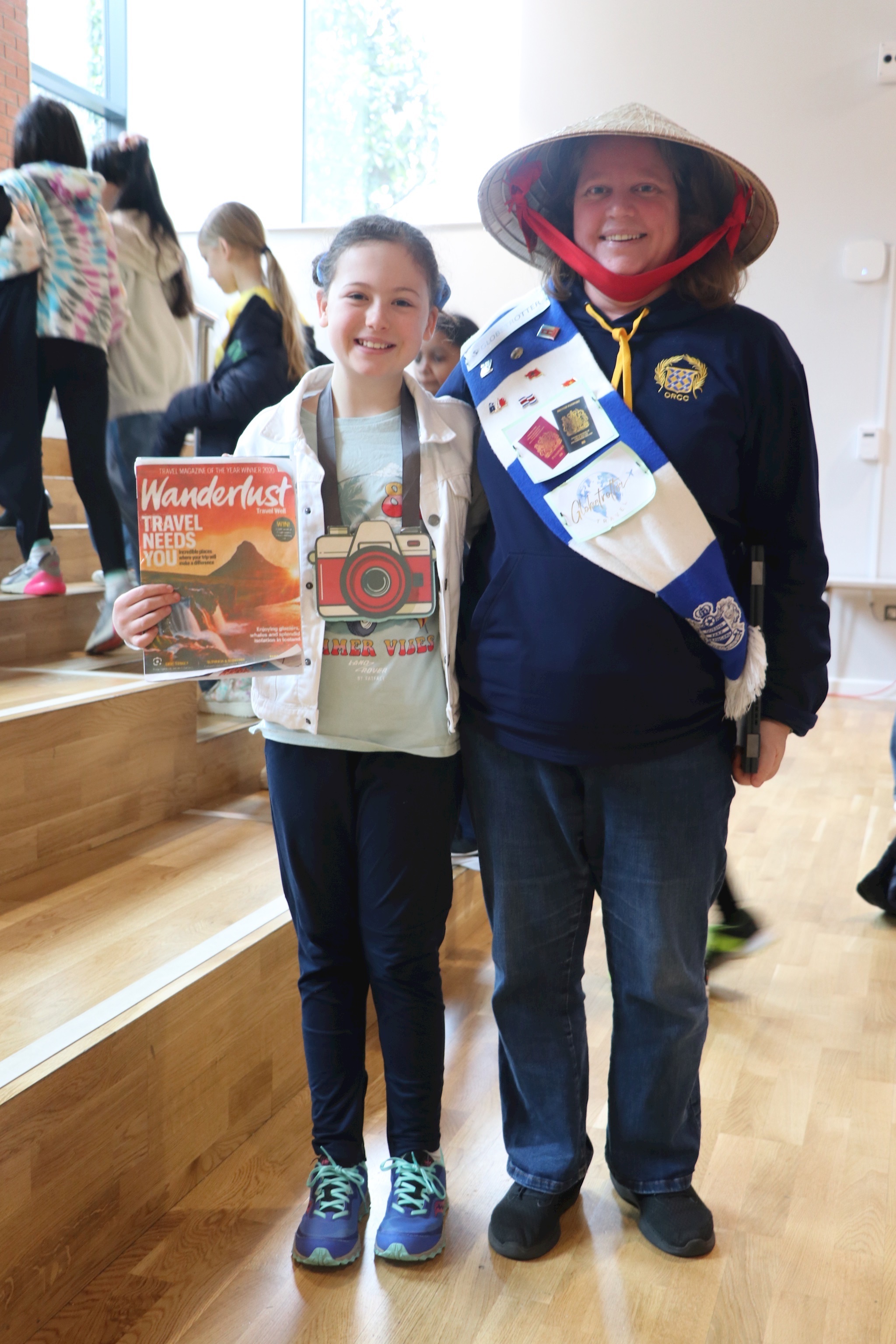 A photograph of a student with Ms Prag. They are dressed as tourists for World Book Day